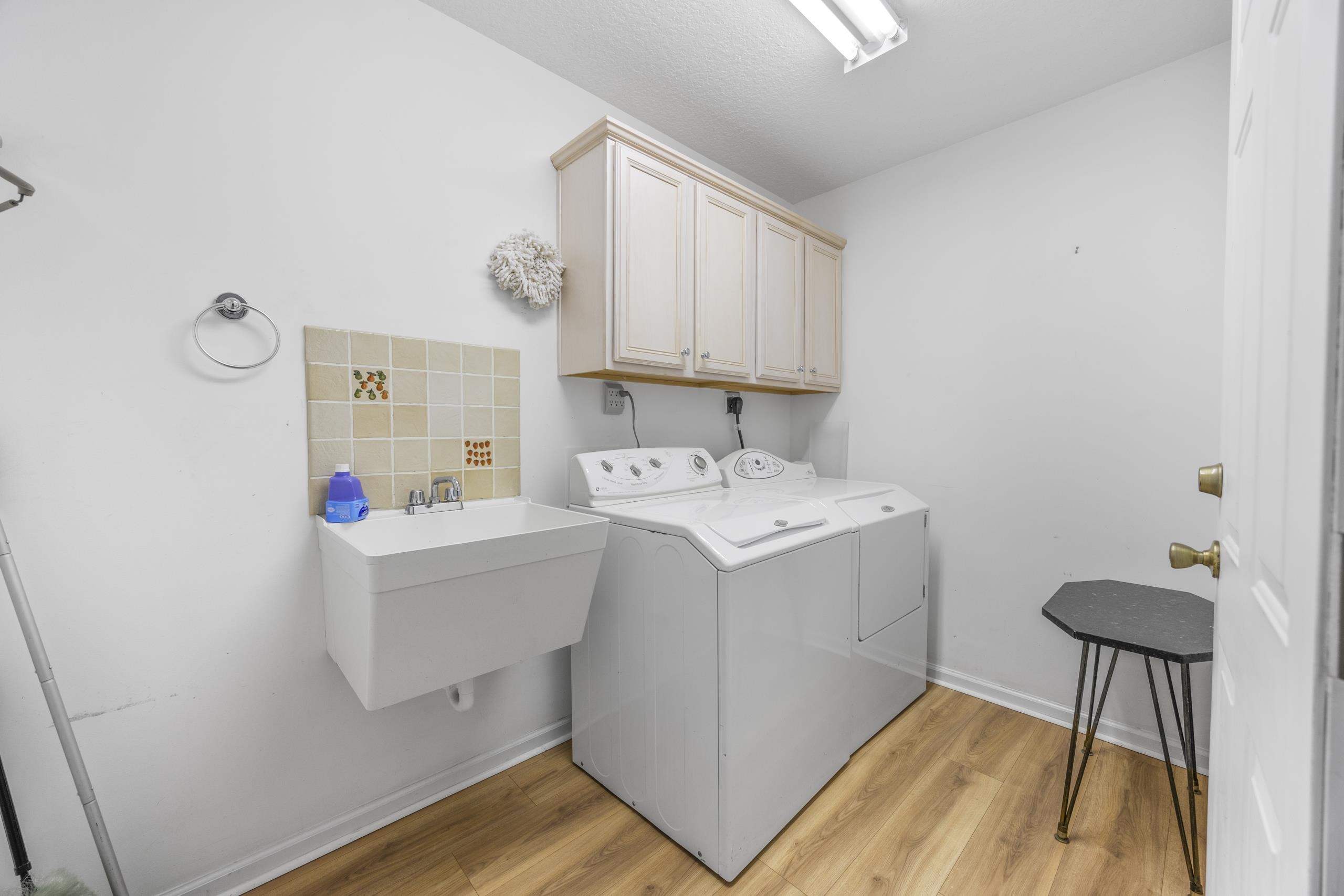 722 Downing Court Longs, SC 29568 - Photo 21 of 40 Washroom with light wood finished floors, washing machine and clothes dryer, and cabinet space