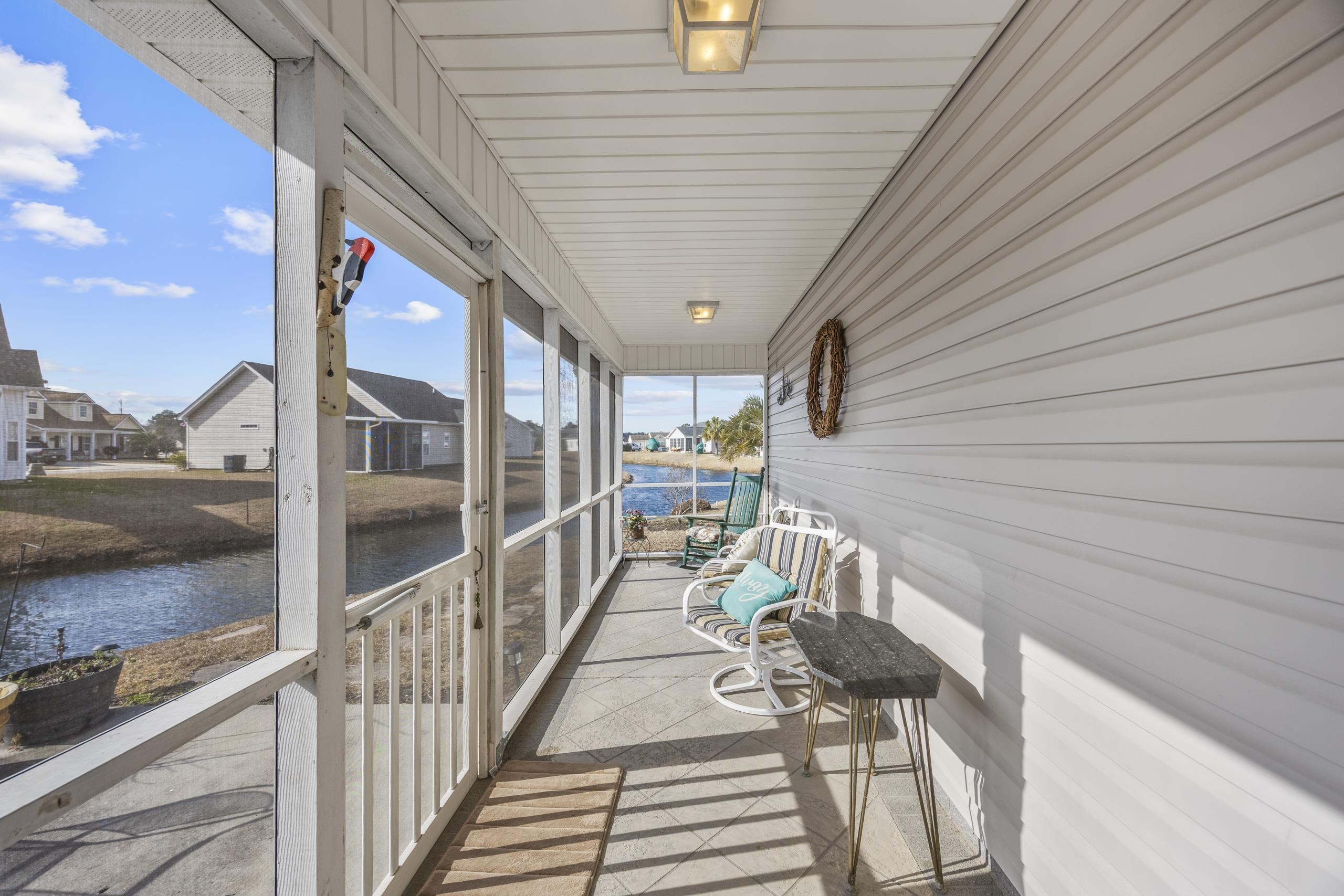 722 Downing Court Longs, SC 29568 - Photo 25 of 40 Screen Porch with a water view and a residential view