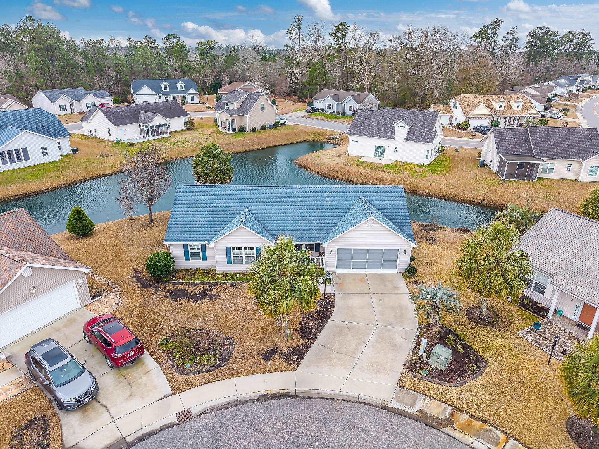 722 Downing Court Longs, SC 29568 - Photo 33 of 40 Aerial perspective of suburban area featuring a large body of water and a tree filled landscape