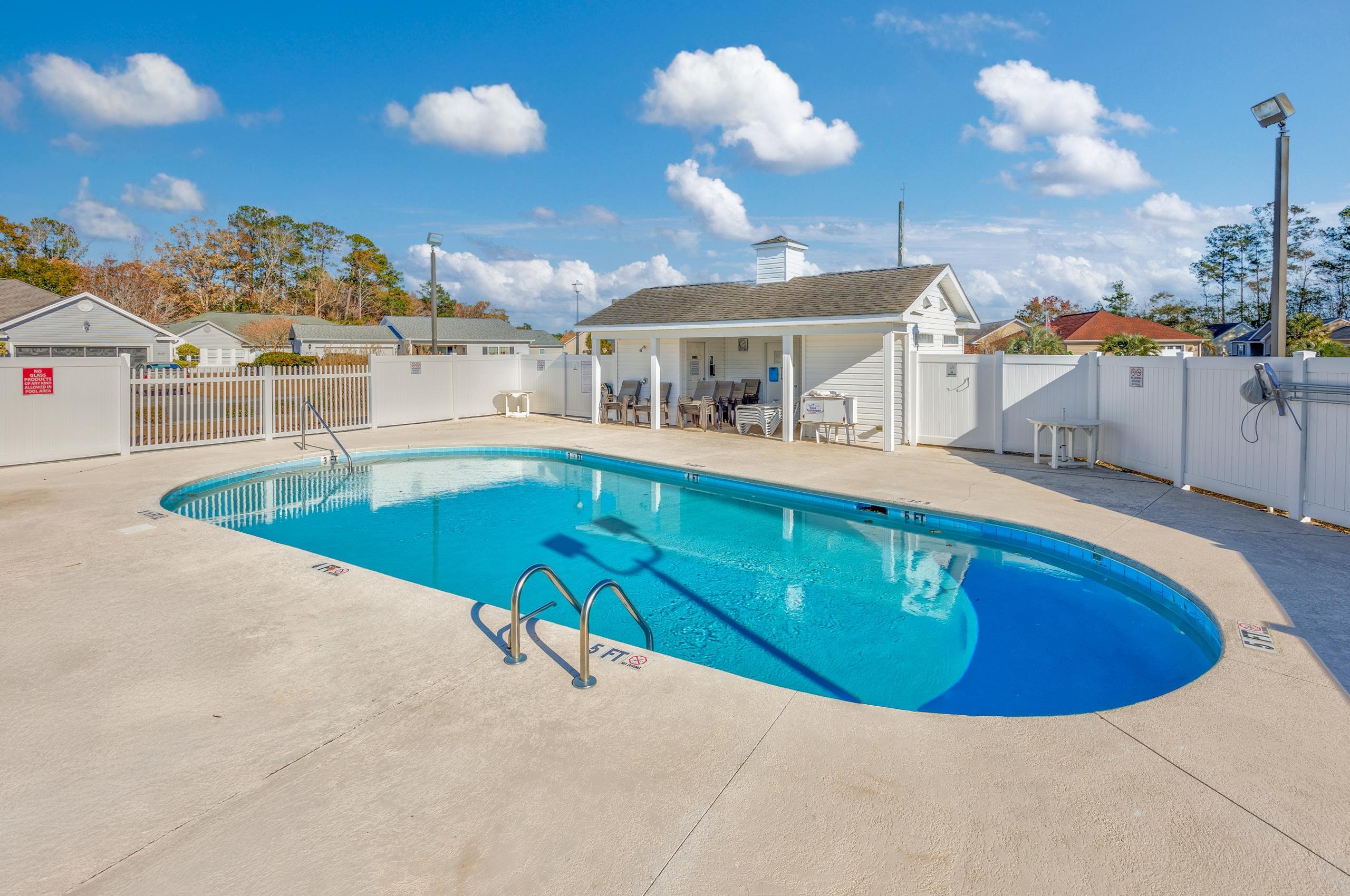 722 Downing Court Longs, SC 29568 - Photo 36 of 40 Community pool with a patio area, a fenced backyard, and a residential view