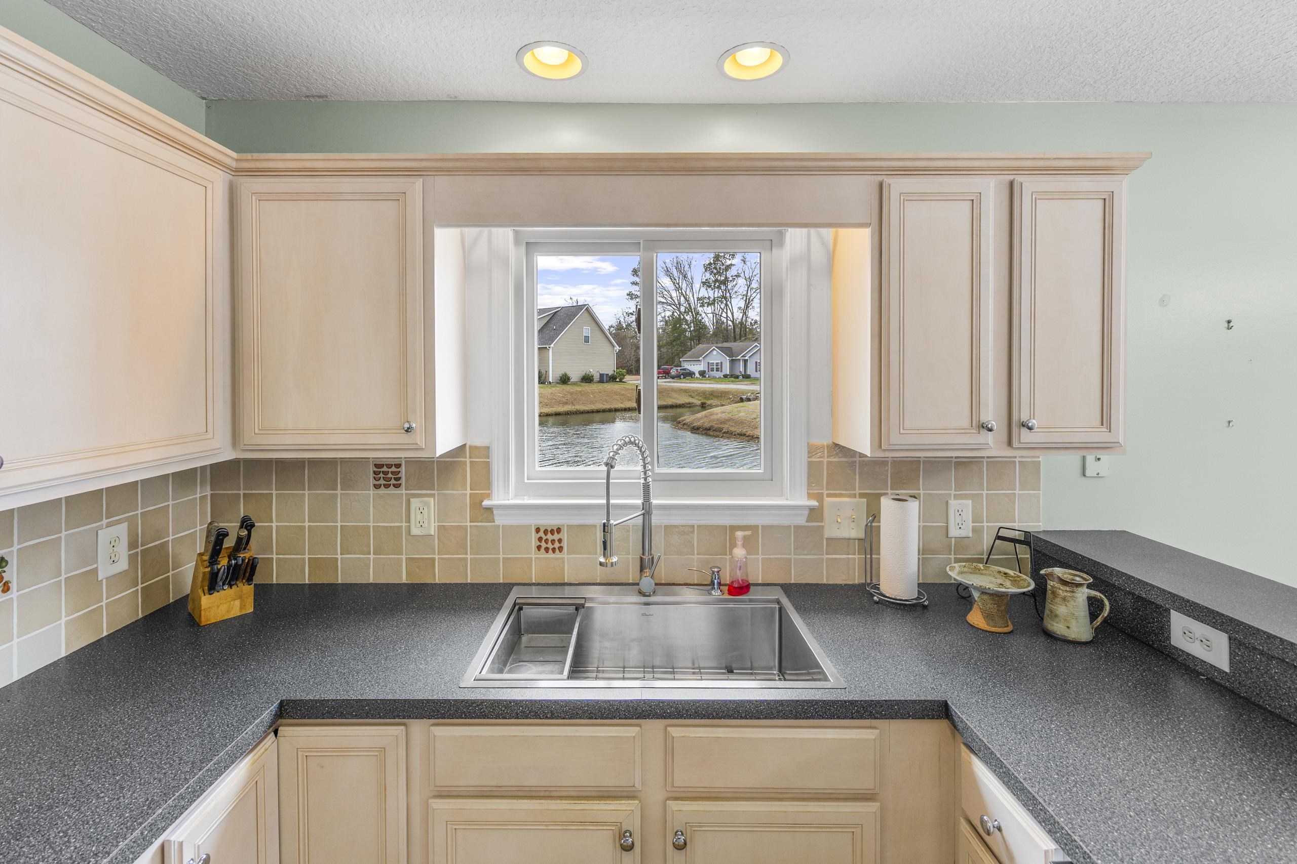 722 Downing Court Longs, SC 29568 - Photo 9 of 40 Kitchen with light brown cabinets, dark countertops, a textured ceiling, and recessed lighting
