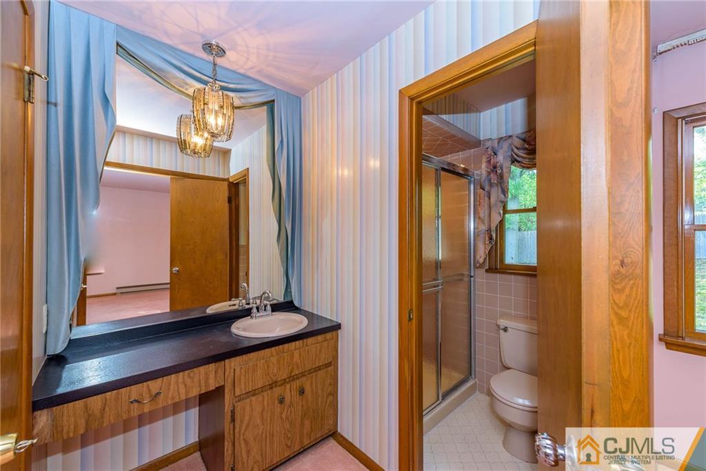 9 Heights Road Wayne, NJ 07470 - Photo 14 of 25 a bathroom with a granite countertop sink toilet and shower