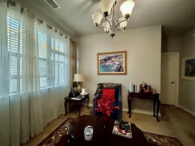 a view of a workspace with furniture and a window