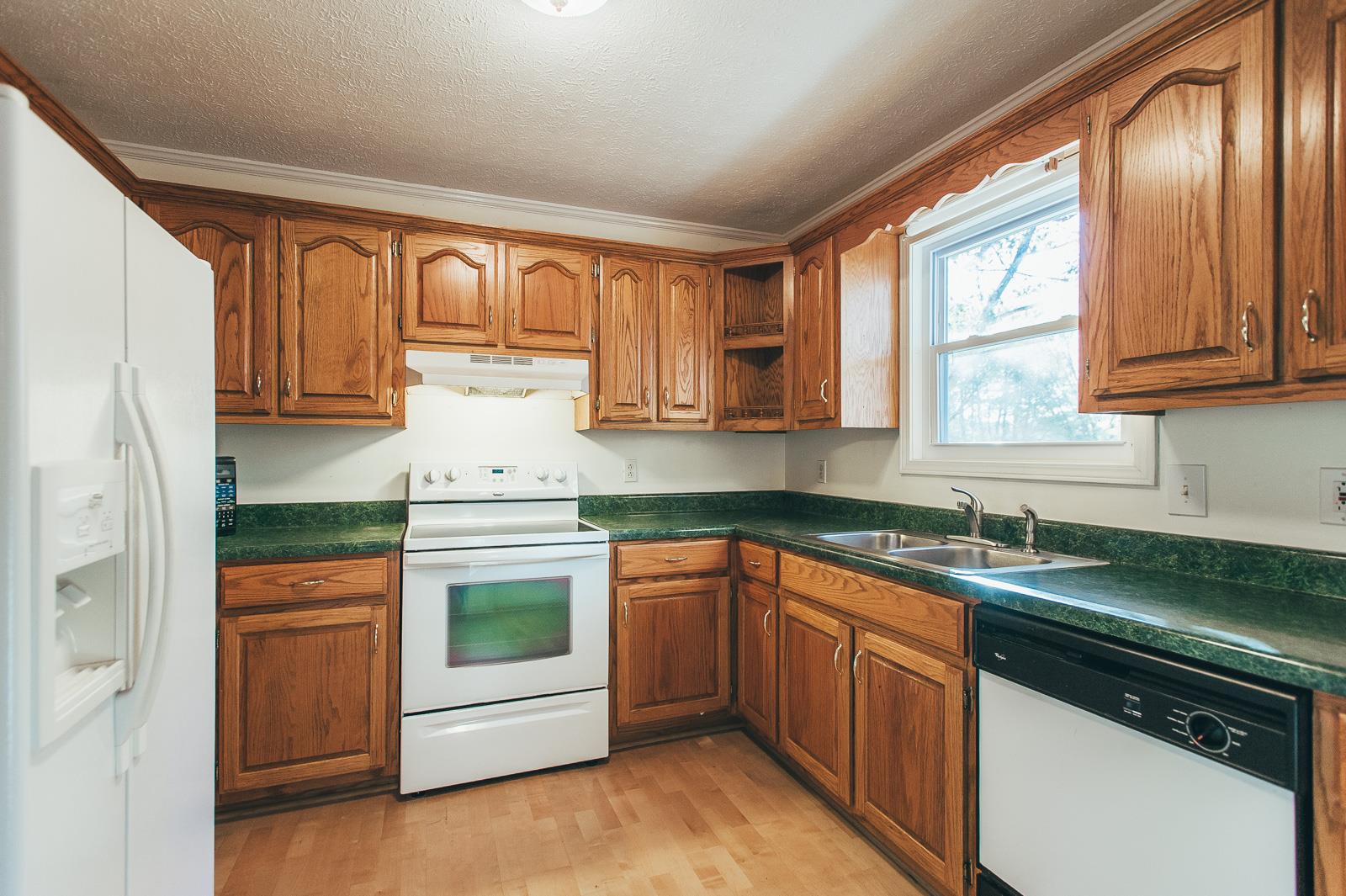 557 S Road Cottontown, TN 37048 - Photo 8 of 24 a kitchen with granite countertop stainless steel appliances white cabinets and a granite counter tops