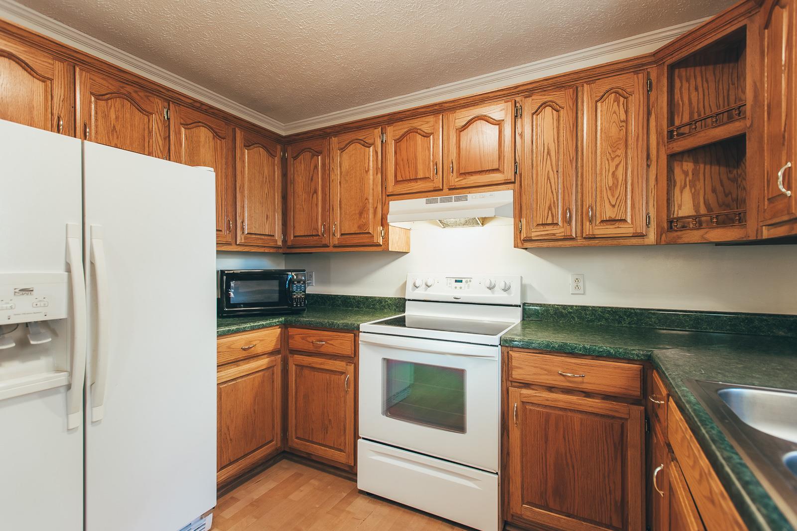 557 S Road Cottontown, TN 37048 - Photo 9 of 24 a kitchen with stainless steel appliances granite countertop a refrigerator sink and cabinets