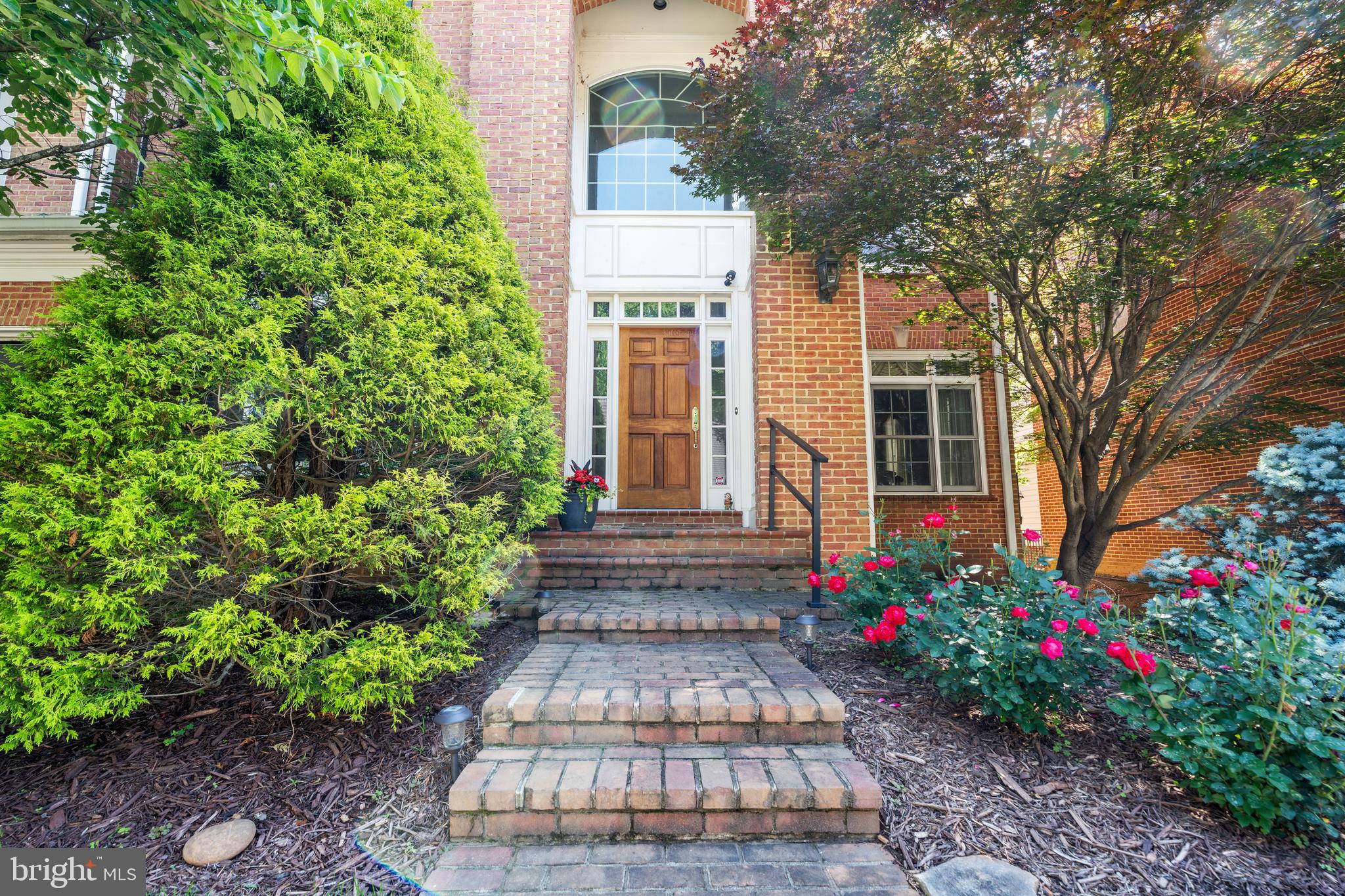 a front view of a house with lots of green space
