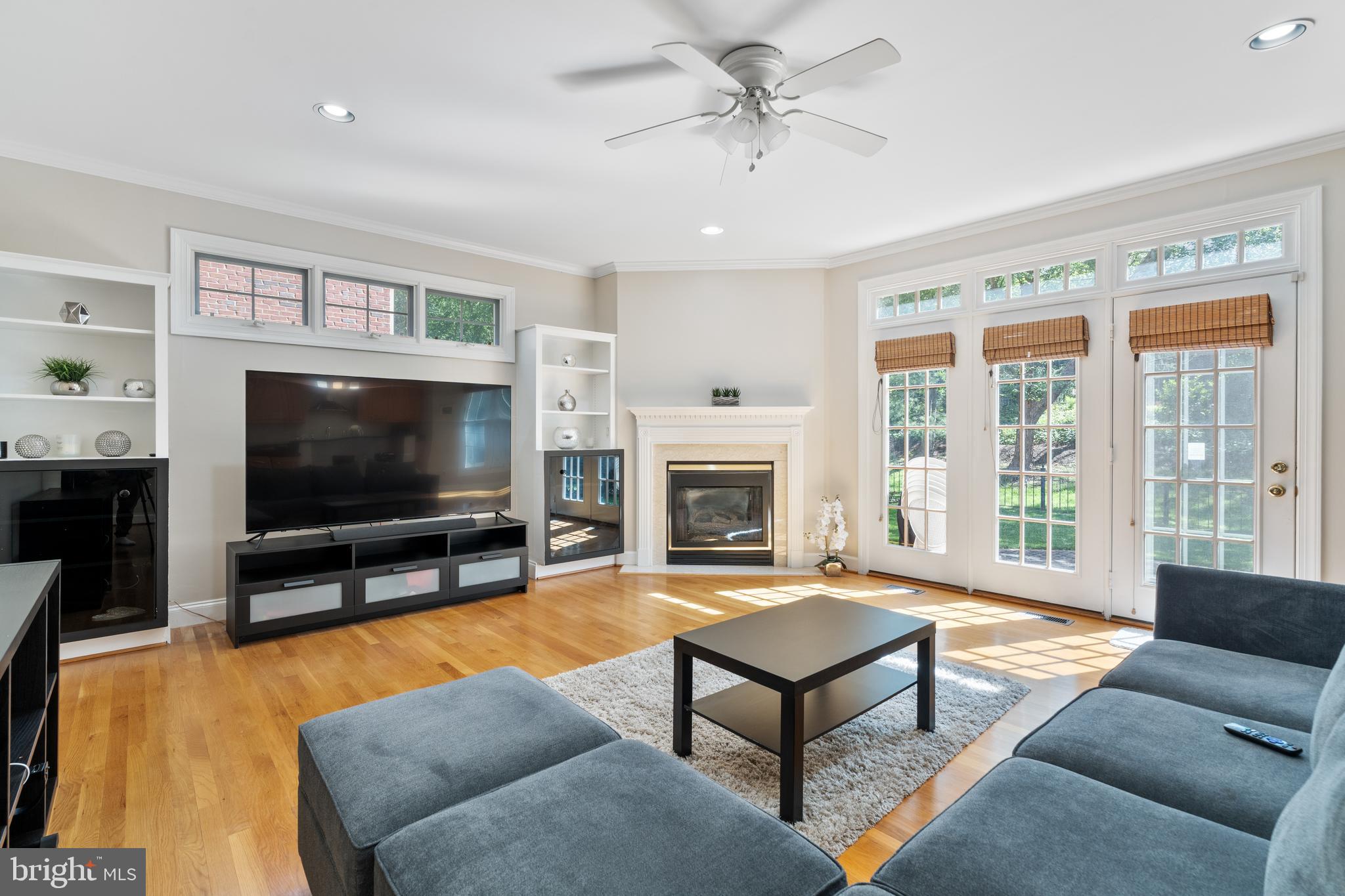 7815 Stable Way Potomac, MD 20854 - Photo 11 of 36 a living room with furniture a flat screen tv and a fireplace