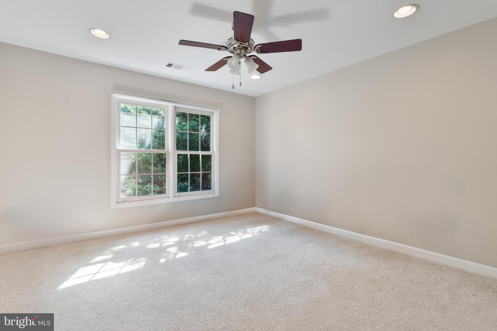7815 Stable Way Potomac, MD 20854 - Photo 15 of 36 an empty room with a window and a fan