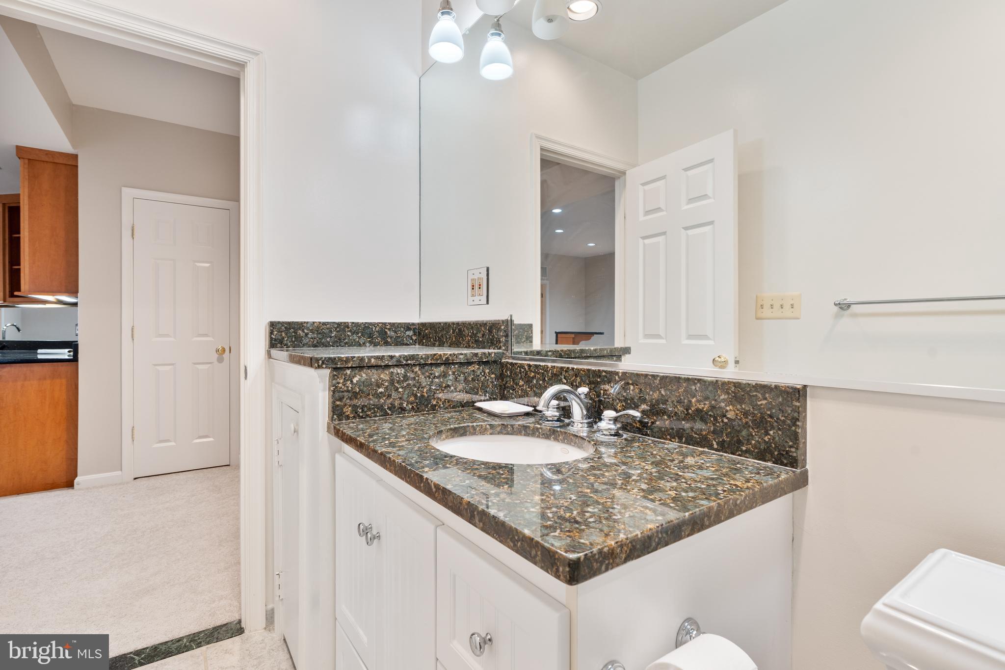 7815 Stable Way Potomac, MD 20854 - Photo 28 of 36 a bathroom with a granite countertop sink and a mirror