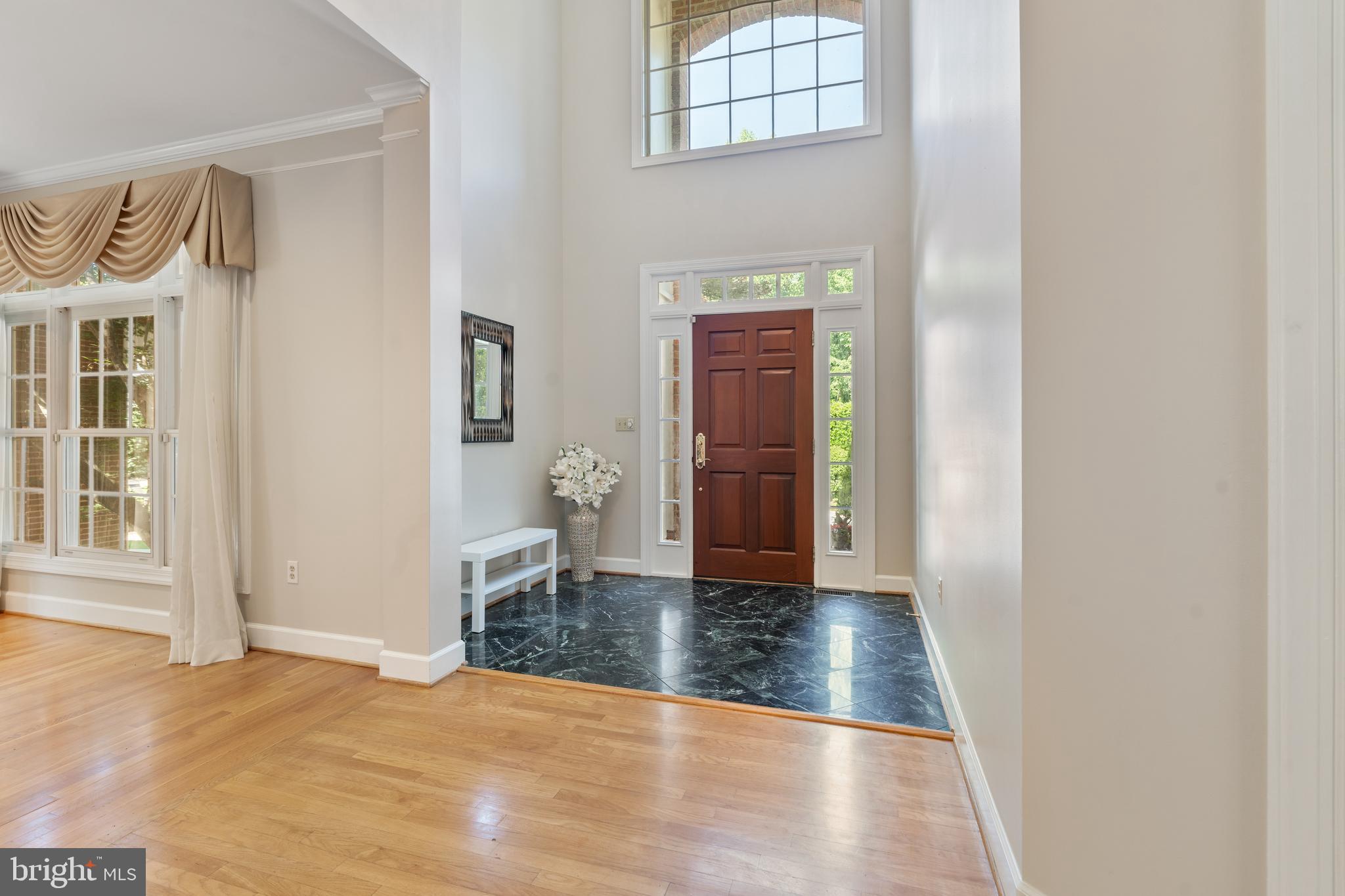 7815 Stable Way Potomac, MD 20854 - Photo 3 of 36 an empty room with wooden floor and windows