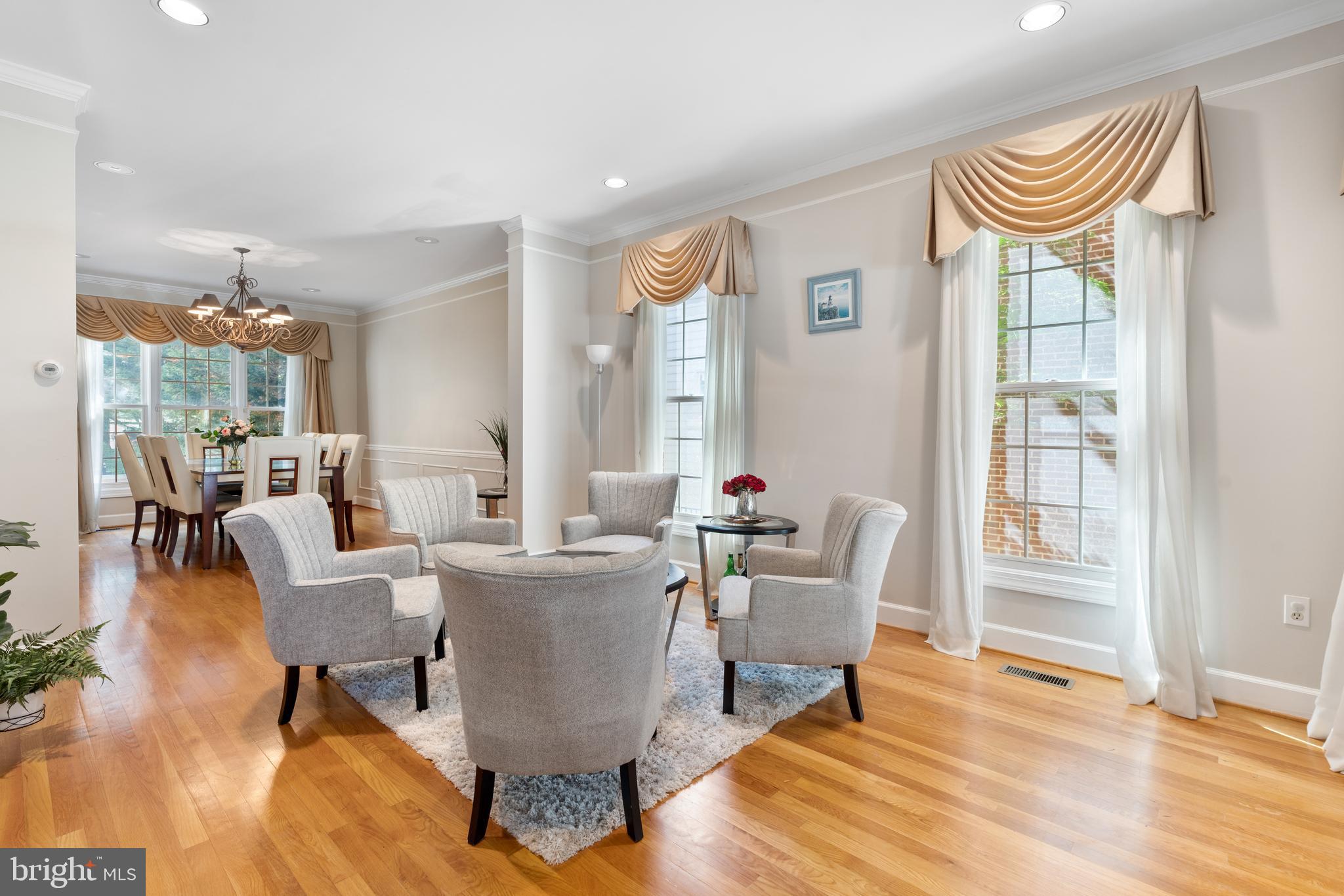 7815 Stable Way Potomac, MD 20854 - Photo 5 of 36 a living room with furniture a lamp and a potted plant