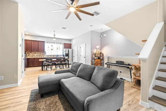 a living room with furniture and kitchen view