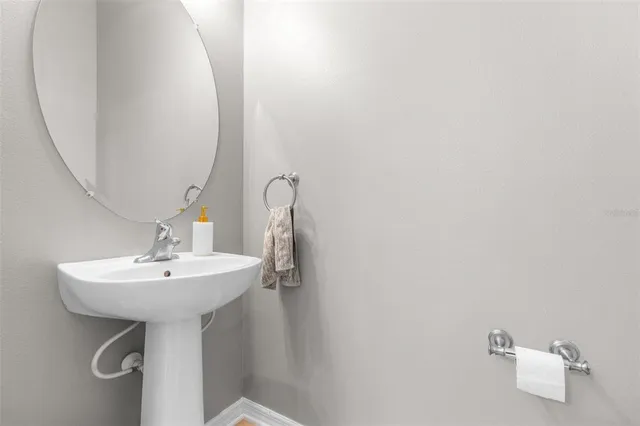 a bathroom with a sink a mirror and a shower