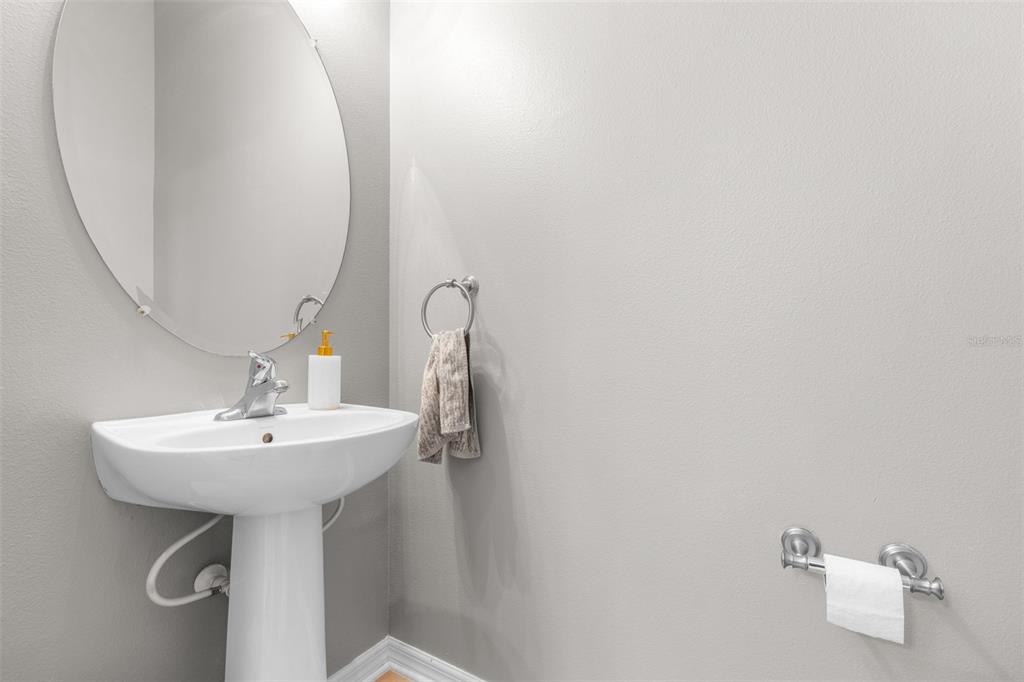 962 Sombra Street Tampa, FL 33619 - Photo 13 of 24 a bathroom with a sink a mirror and a shower