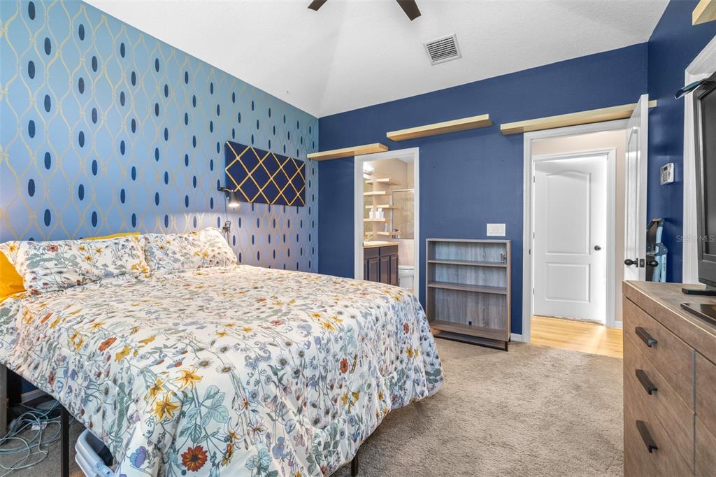 962 Sombra Street Tampa, FL 33619 - Photo 16 of 24 a bedroom with a large bed and a dresser