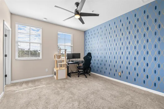 a view of a workspace with furniture and a window