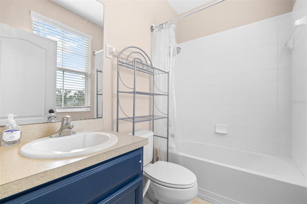 962 Sombra Street Tampa, FL 33619 - Photo 21 of 24 a bathroom with a sink toilet and shower