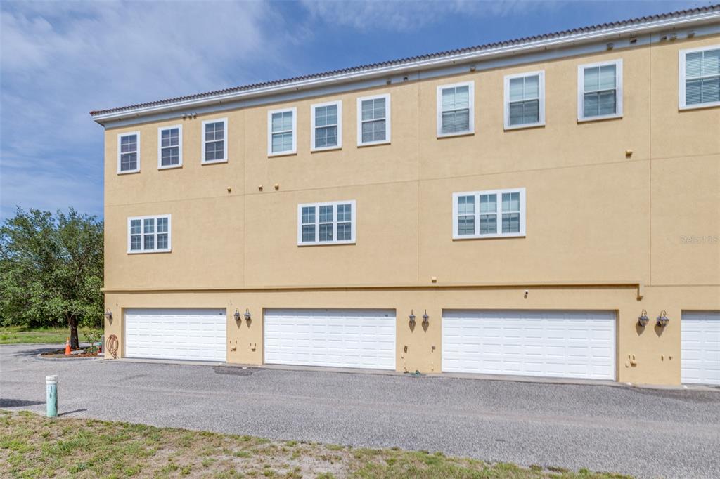 962 Sombra Street Tampa, FL 33619 - Photo 22 of 24 a front view of a house with a yard and garage