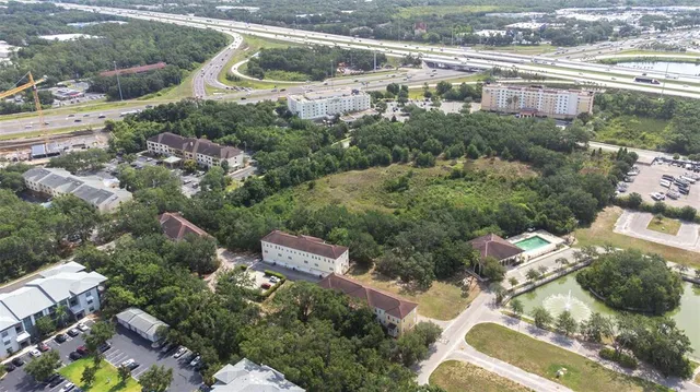 an aerial view of a house with a yard and lake view