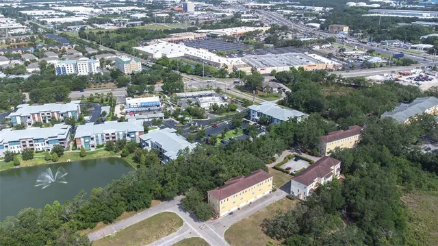 an aerial view of residential houses with outdoor space and lake view
