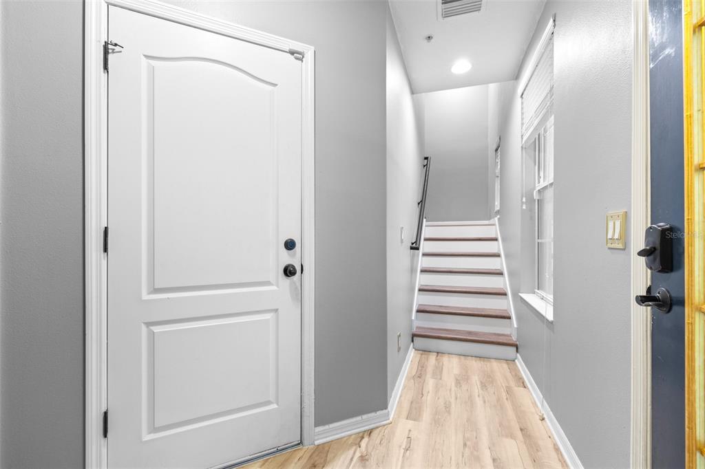 962 Sombra Street Tampa, FL 33619 - Photo 4 of 24 a view of a hallway with wooden floor and entryway