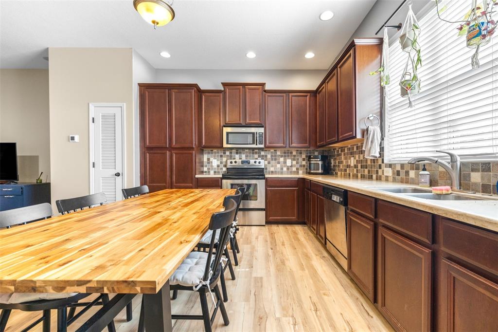 962 Sombra Street Tampa, FL 33619 - Photo 7 of 24 a kitchen with stainless steel appliances kitchen island granite countertop a sink and cabinets