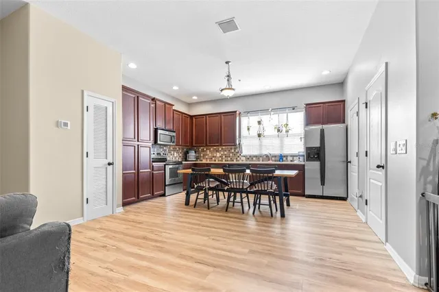 a view of a dining room with furniture and wooden floor