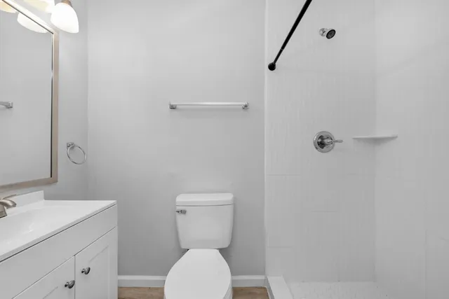 a white toilet sitting next to a bathroom sink