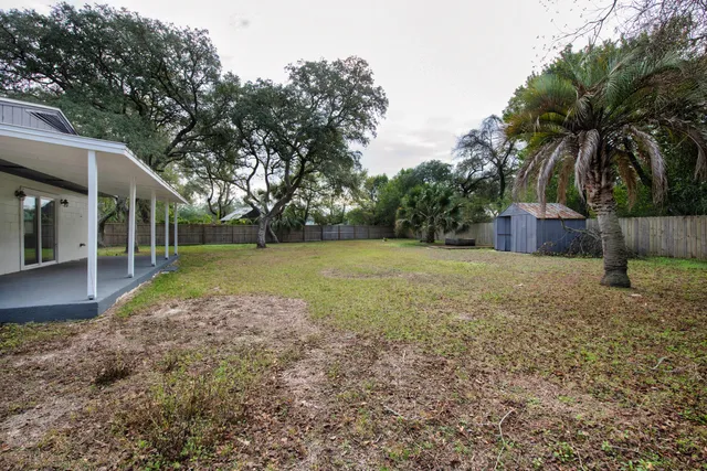 a backyard of a house with table and chairs
