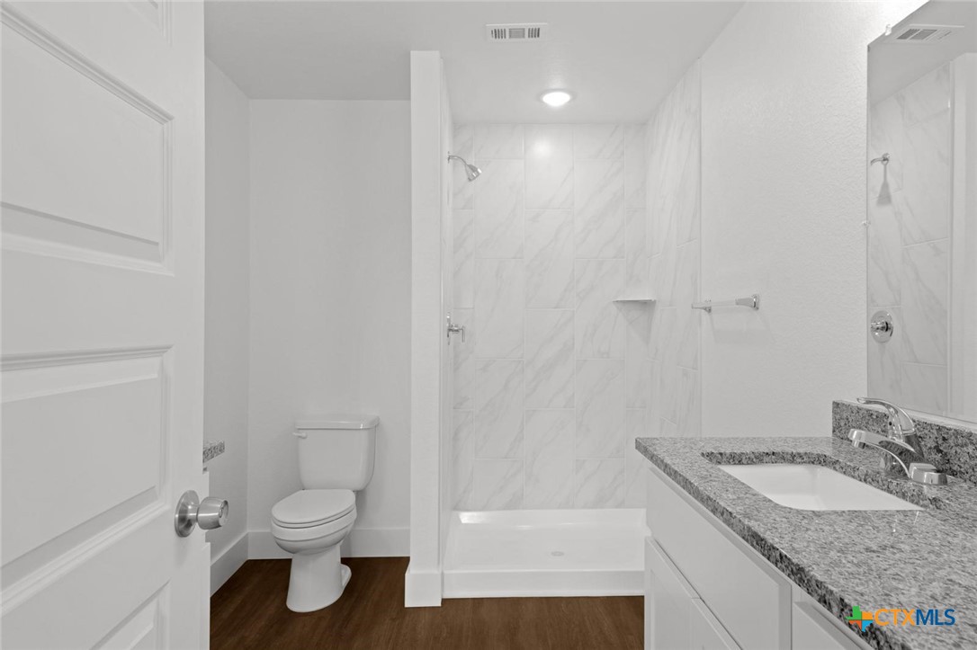 1924 Royal Loop Belton, TX 76513 - Photo 8 of 15 a bathroom with a granite countertop sink toilet and shower