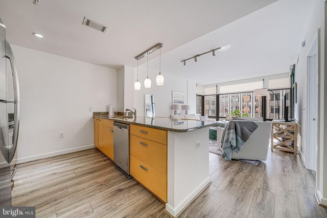 a kitchen with sink cabinets and wooden floor