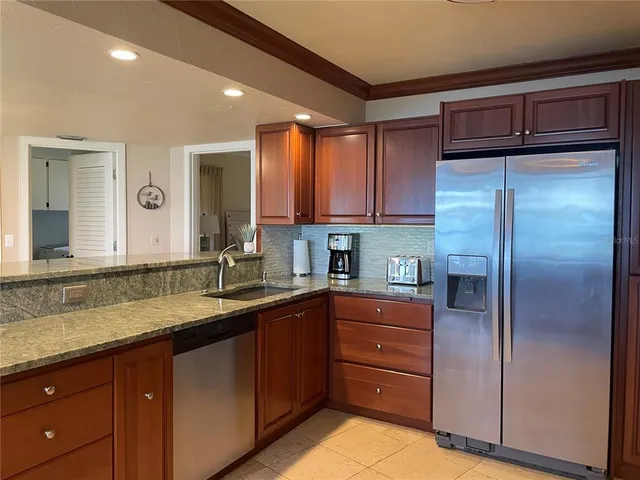 a kitchen with a sink and refrigerator