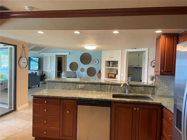 a bathroom with a granite countertop double vanity sink and a mirror