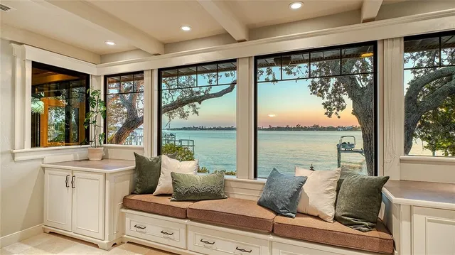 a living room with furniture and large windows