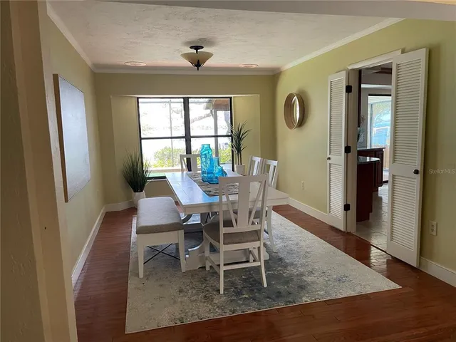 a view of a dining room with furniture window and wooden floor