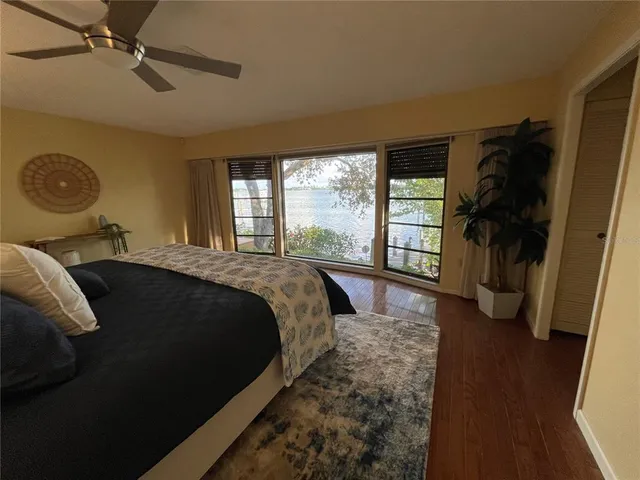 a bedroom with a large bed and a large window