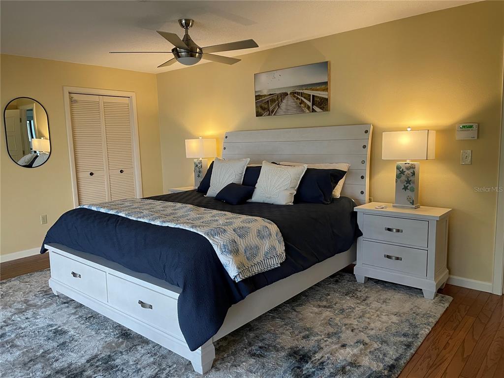 421 Waterside Lane Nokomis, FL 34275 - Photo 24 of 48 a bedroom with a bed and a dresser