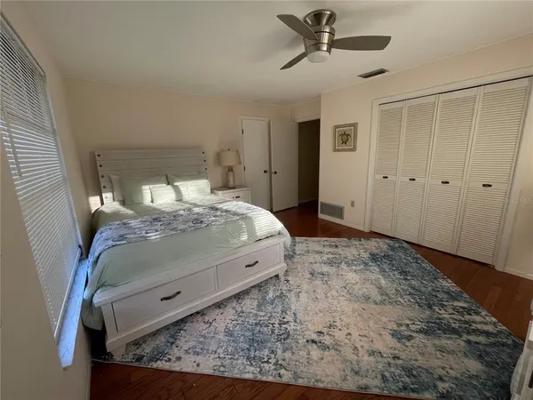 a bed sitting in a bedroom next to a window