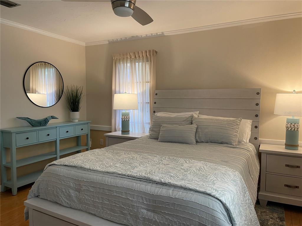 421 Waterside Lane Nokomis, FL 34275 - Photo 35 of 48 a bedroom with a bed and a chandelier