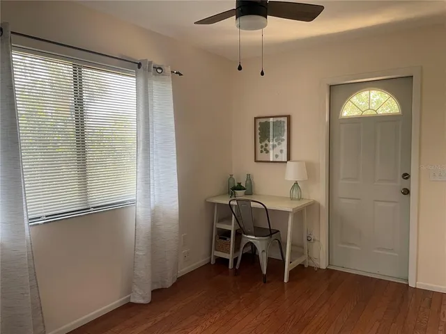 a view of a livingroom with furniture and a window