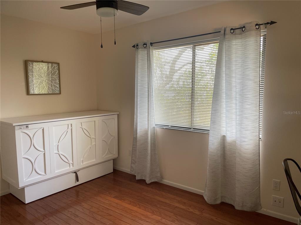 421 Waterside Lane Nokomis, FL 34275 - Photo 39 of 48 a view of an empty room with wooden floor and a window