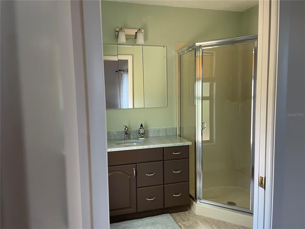 421 Waterside Lane Nokomis, FL 34275 - Photo 40 of 48 a bathroom with a shower a sink and mirror