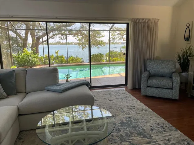 a living room with furniture and a floor to ceiling window