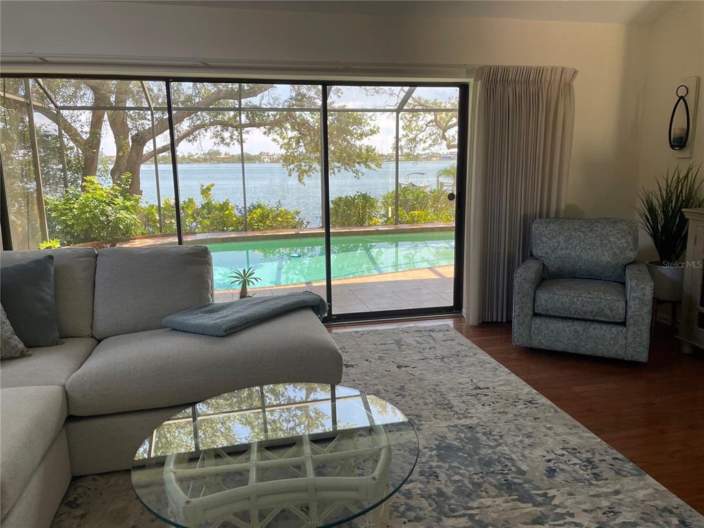 421 Waterside Lane Nokomis, FL 34275 - Photo 7 of 48 a living room with furniture and a floor to ceiling window