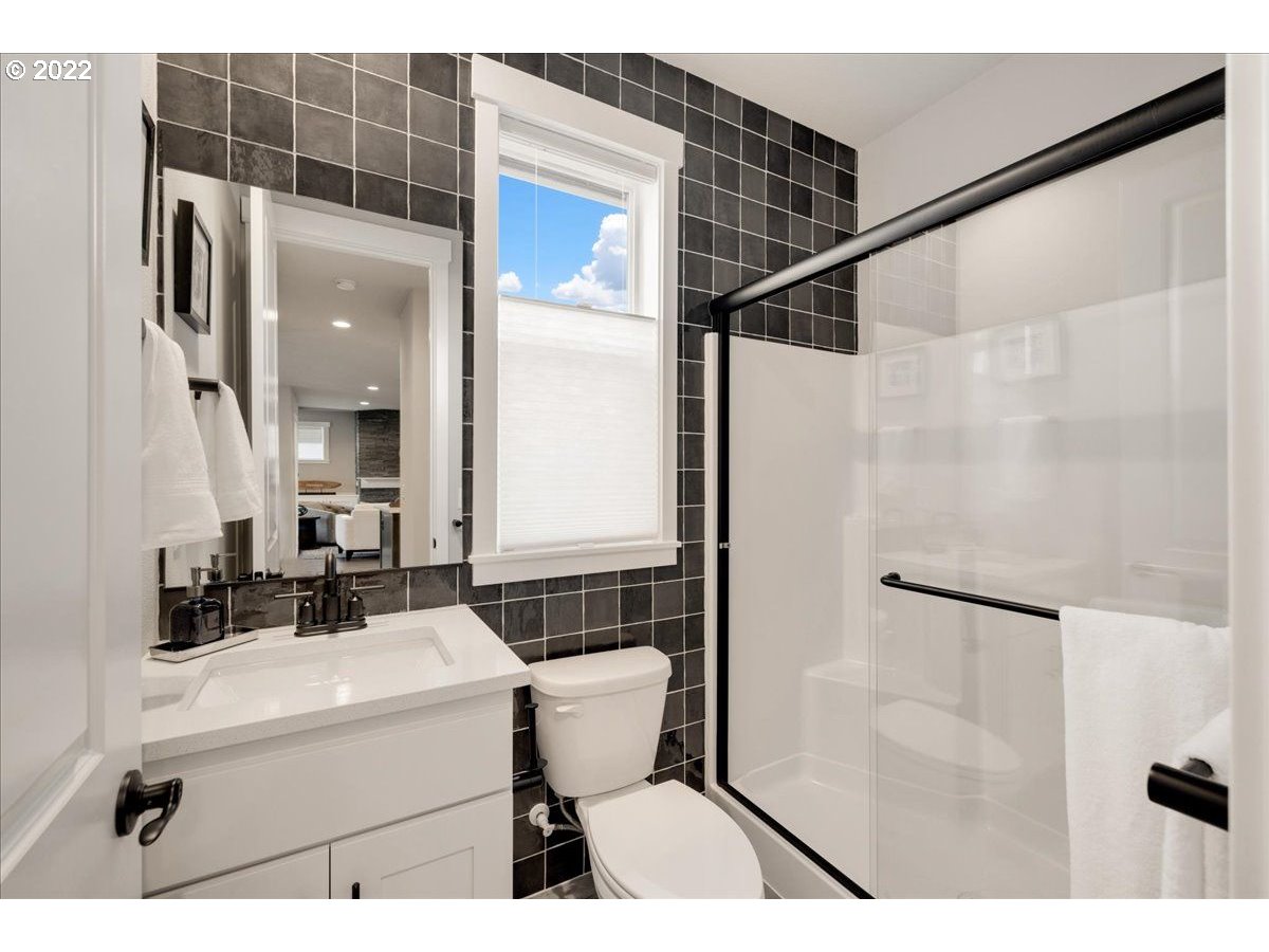 8534 North 5th Street, Unit LT 32 Ridgefield, WA 98642 - Photo 13 of 26 a bathroom with a sink toilet a mirror and shower