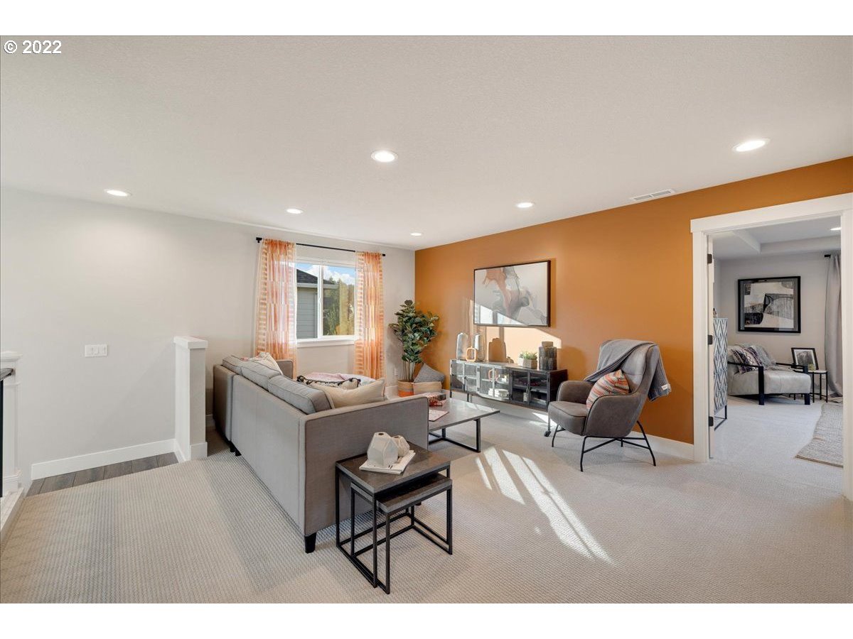 8534 North 5th Street, Unit LT 32 Ridgefield, WA 98642 - Photo 14 of 26 a living room with furniture and a wooden floor