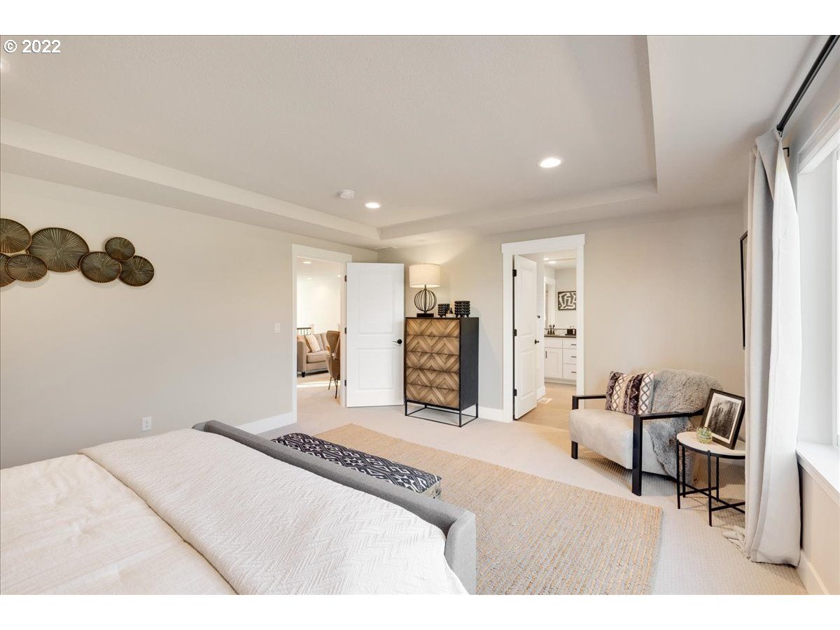 8534 North 5th Street, Unit LT 32 Ridgefield, WA 98642 - Photo 18 of 26 a spacious bedroom with a bed and a chair