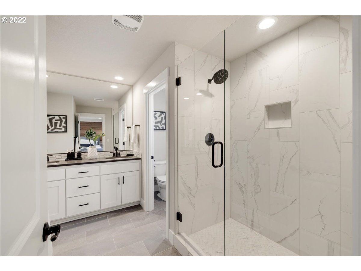 8534 North 5th Street, Unit LT 32 Ridgefield, WA 98642 - Photo 19 of 26 a bathroom with a granite countertop sink a mirror and shower