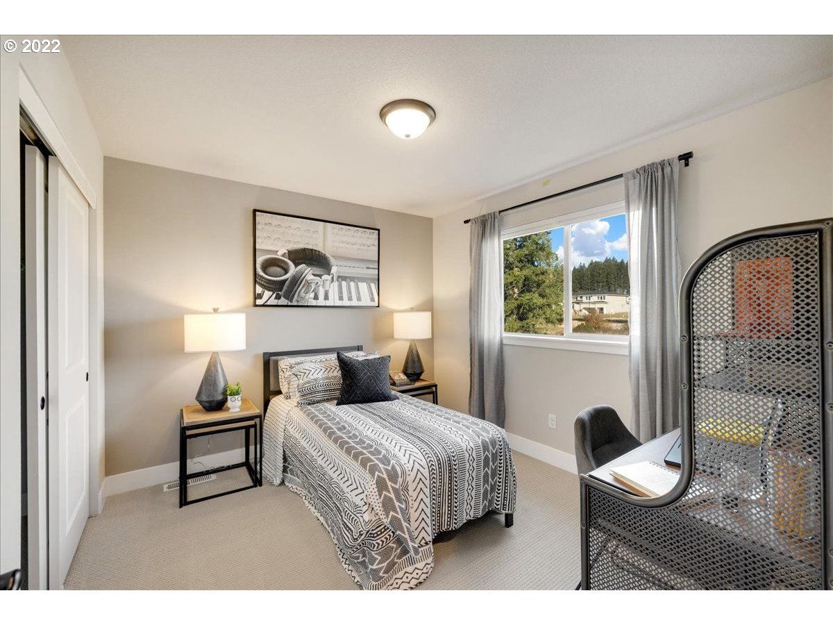 8534 North 5th Street, Unit LT 32 Ridgefield, WA 98642 - Photo 21 of 26 a bedroom with a bed and a large window