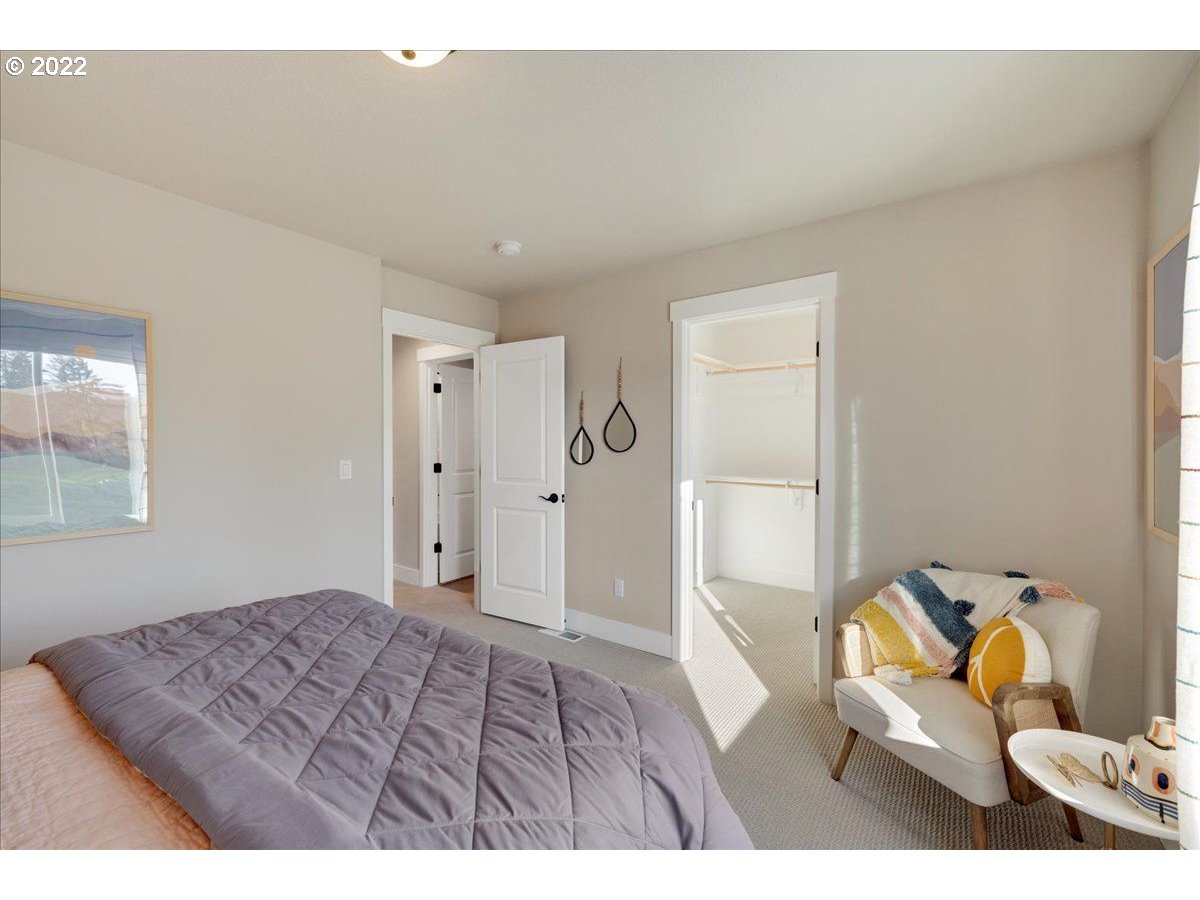 8534 North 5th Street, Unit LT 32 Ridgefield, WA 98642 - Photo 22 of 26 a bedroom with a bed and a window